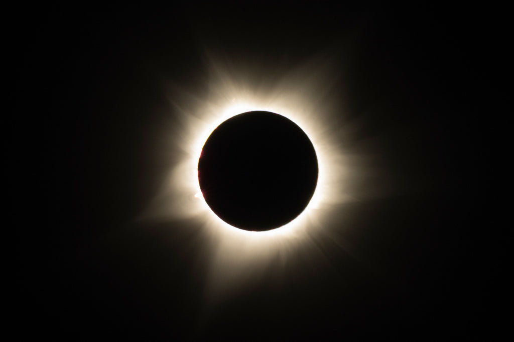 Total solar eclipse with the Sun's corona glowing around the Moon