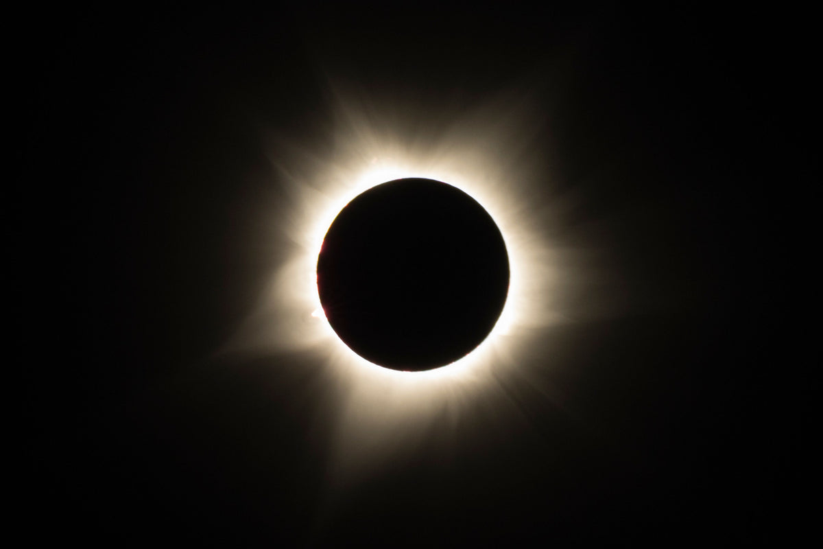 Total solar eclipse with the Sun's corona glowing around the Moon
